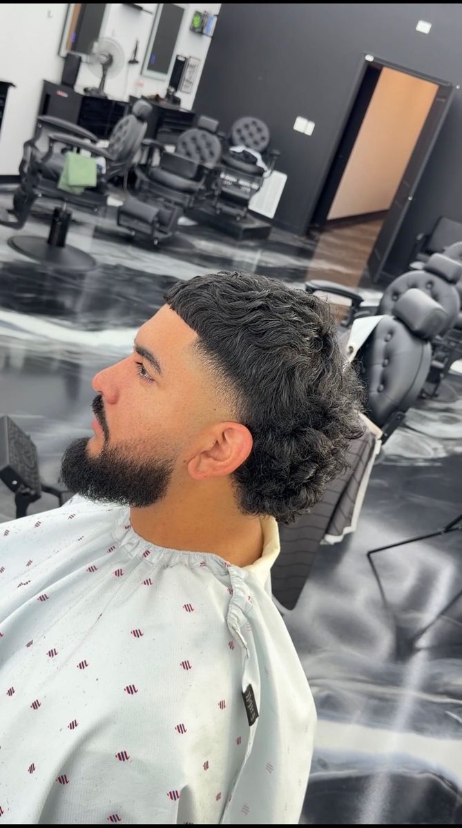 Curly mullet with low fade and beard